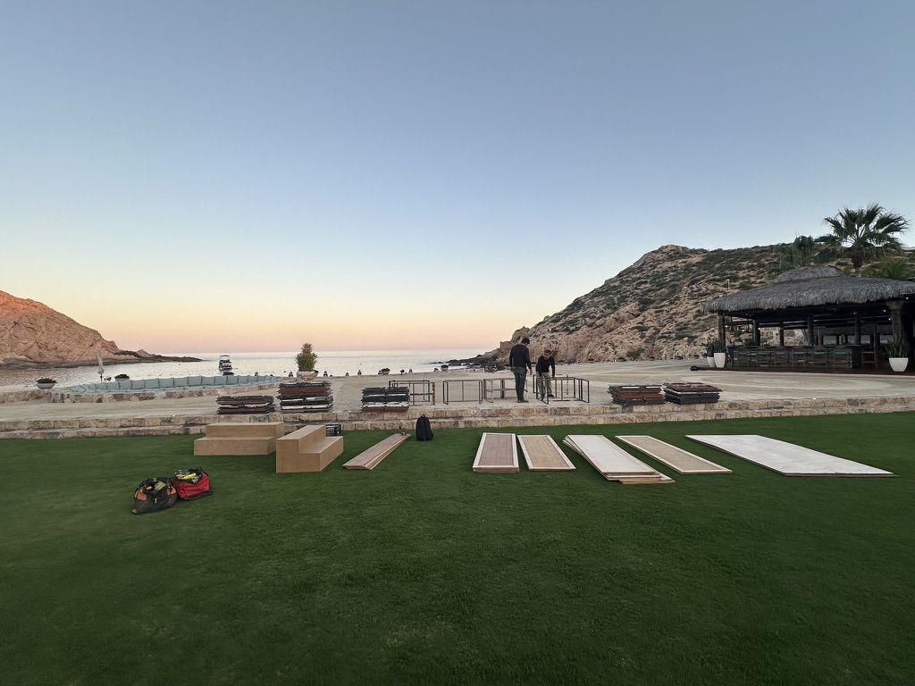 Production load-in at sunset resort lawn overlooking ocean Cabo San Lucas Baja California Sur