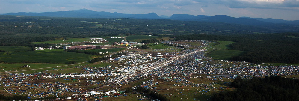 Wide aerial of full festival footprint camping and performance areas Coventry VT 2004